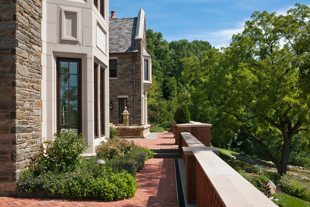 This is an example of an expansive classic back garden in Philadelphia with a water feature and gravel.