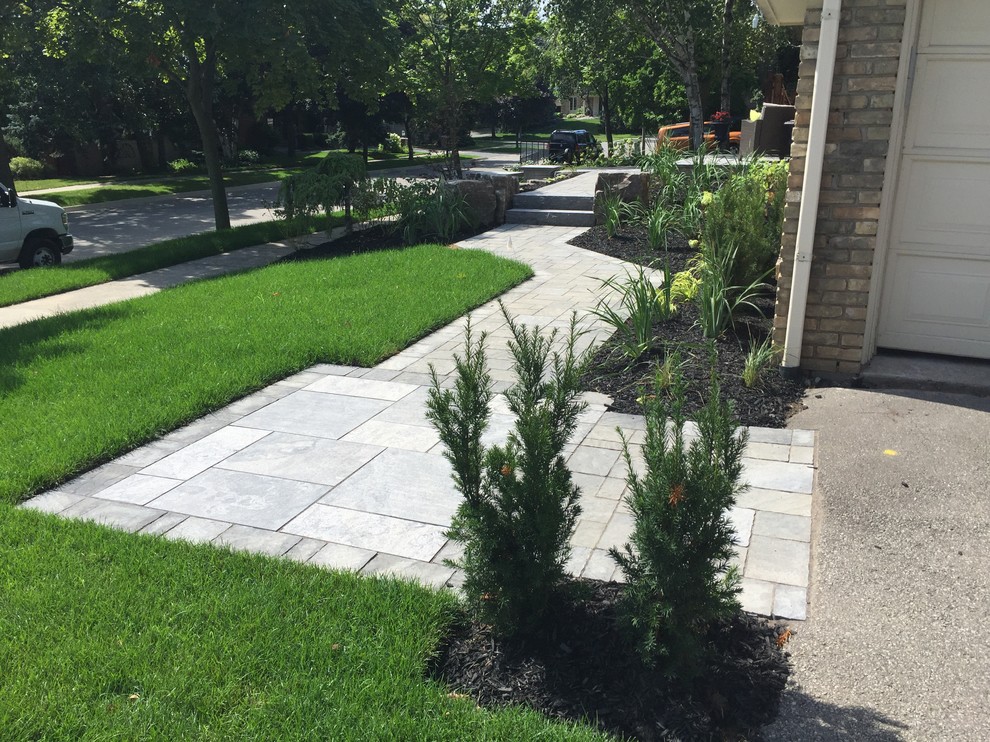 Medium sized contemporary front formal partial sun garden in Toronto with a garden path and concrete paving.