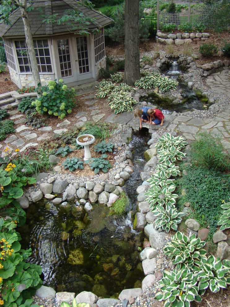 Inspiration for a traditional garden in Minneapolis with a water feature.