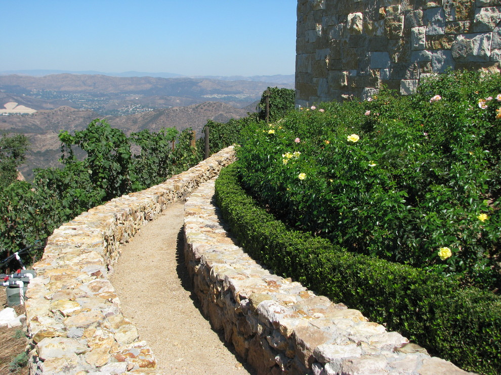Design ideas for a huge mediterranean full sun hillside gravel garden path in Los Angeles for summer.