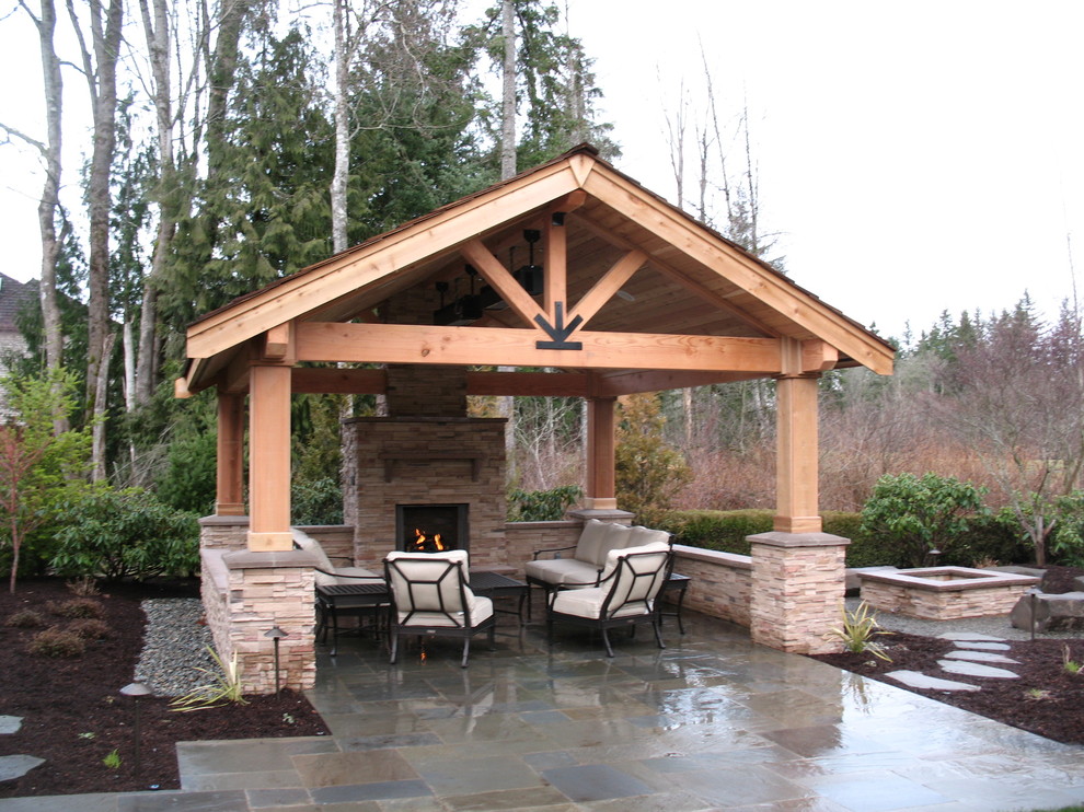 Inspiration for a large timeless stone patio remodel in Seattle with a fire pit