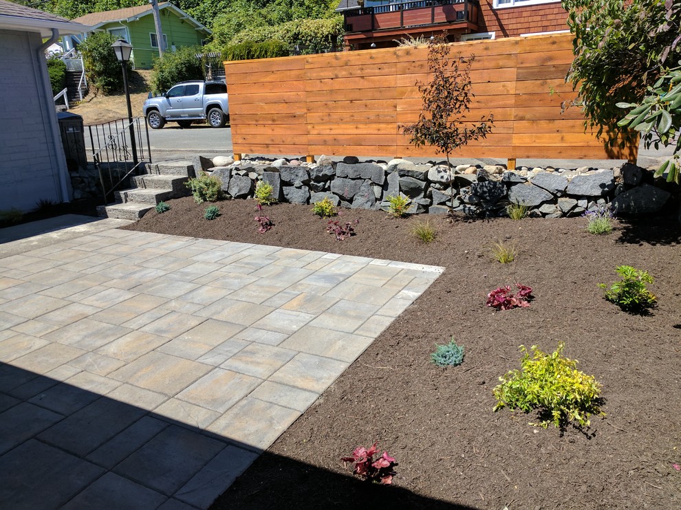 Inspiration for a medium sized traditional courtyard xeriscape full sun garden in Seattle with a retaining wall and concrete paving.