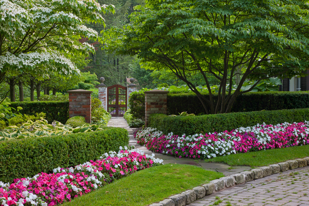 Immagine di un giardino classico esposto a mezz'ombra con pavimentazioni in pietra naturale