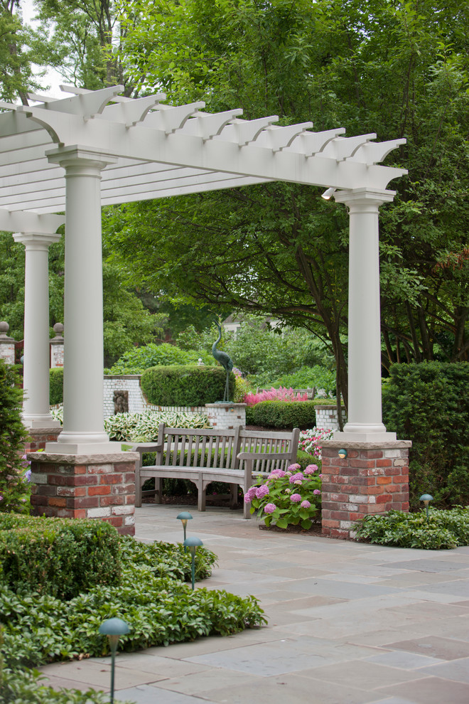 Inspiration for a huge traditional backyard stone formal garden in Detroit.