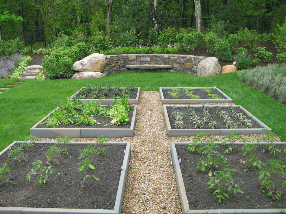 Large coastal back formal full sun garden in Boston with a vegetable patch and gravel.