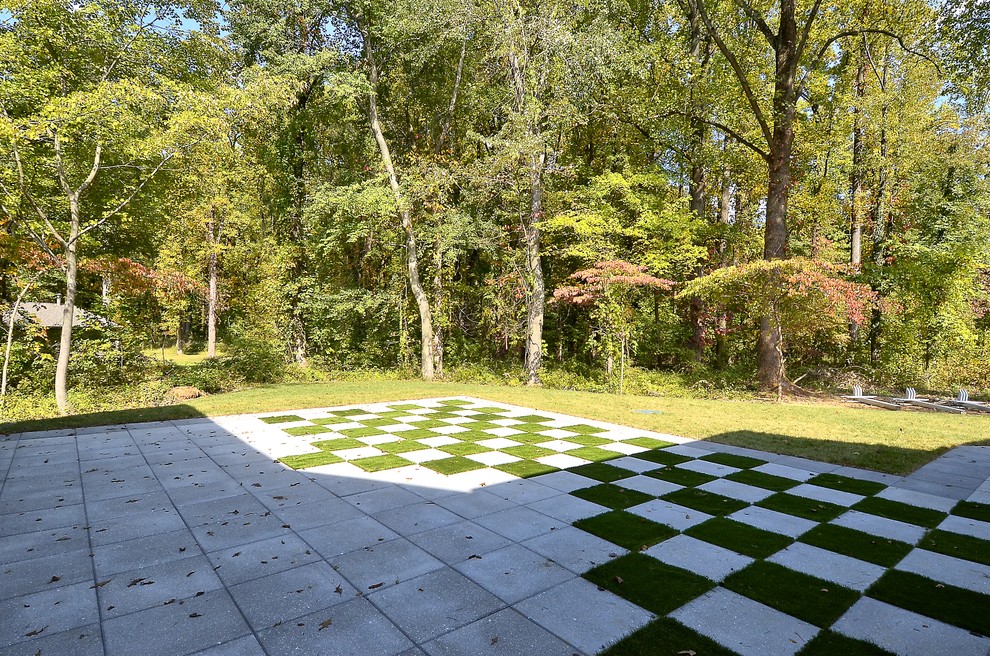 This is an example of a mid-sized craftsman partial sun backyard concrete paver landscaping in Baltimore for spring.