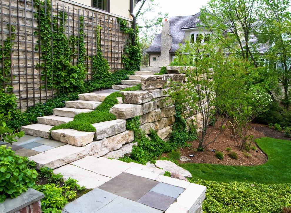Design ideas for a traditional sloped garden steps in Chicago with natural stone paving.