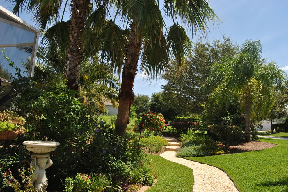 Design ideas for a large tropical full sun backyard gravel landscaping in Orlando for spring.