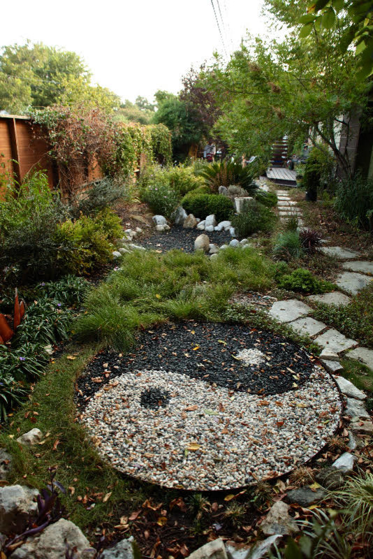 This is an example of a mid-sized asian partial sun backyard landscaping in Austin for summer.
