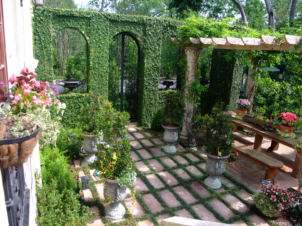 Design ideas for a mediterranean partial sun garden in Houston with a potted garden.