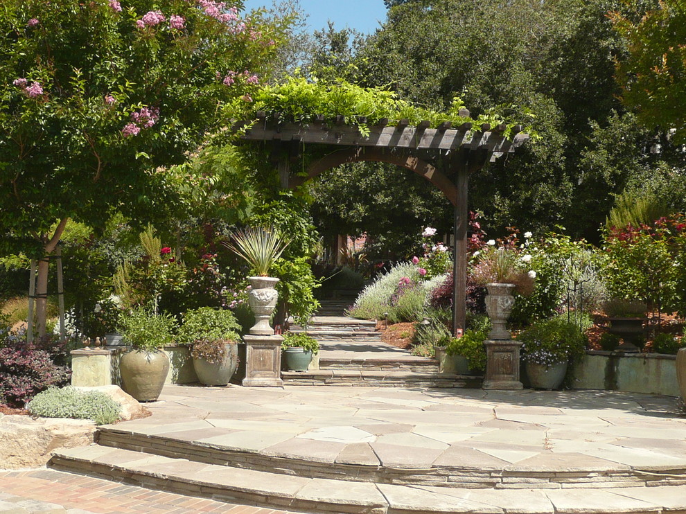 This is an example of a large traditional full sun backyard stone landscaping in San Francisco.