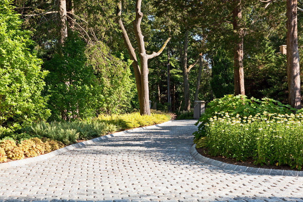 Inspiration for an expansive mediterranean front driveway partial sun garden in New York with concrete paving.