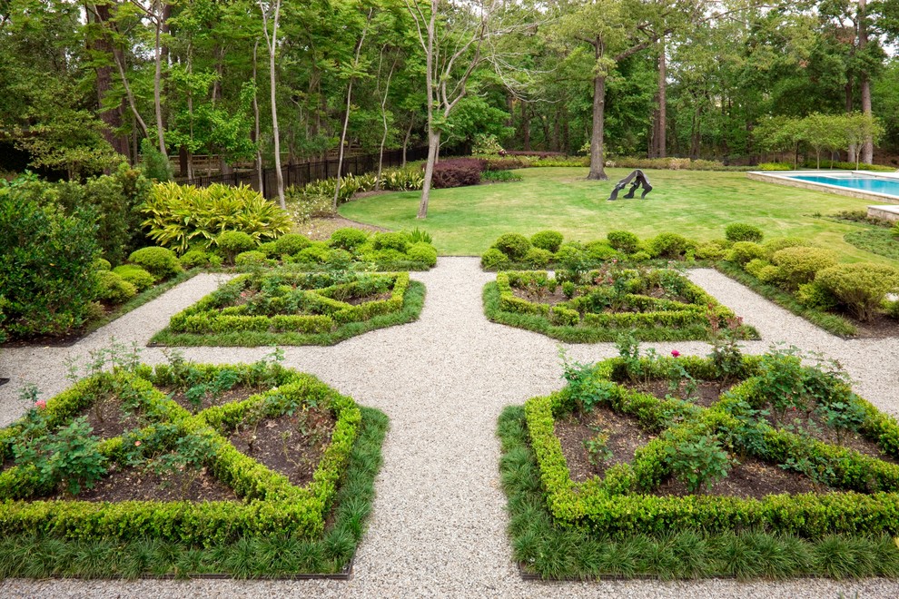 This is an example of an expansive mediterranean back formal garden in Houston with gravel.