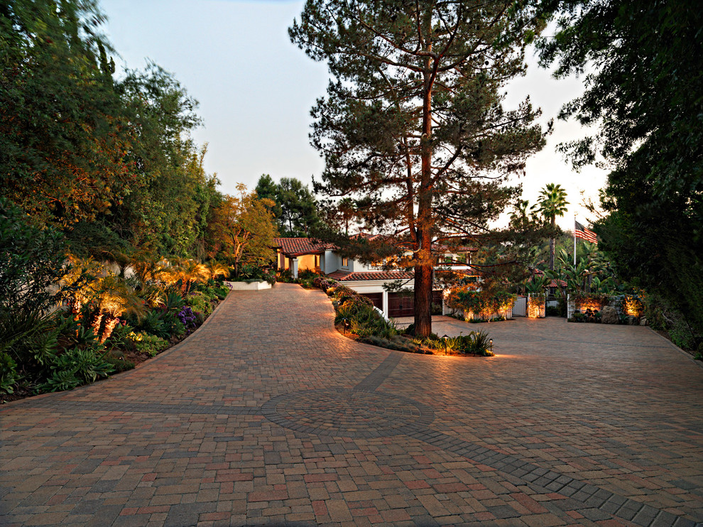 Mediterranean driveway garden in Orange County with natural stone paving.
