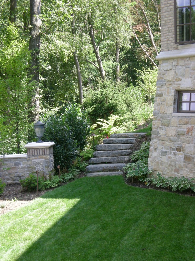 Design ideas for a large mediterranean back partial sun garden for summer in New York with a potted garden and natural stone paving.