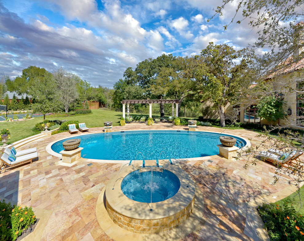 Inspiration for a mediterranean backyard pool fountain remodel in Dallas