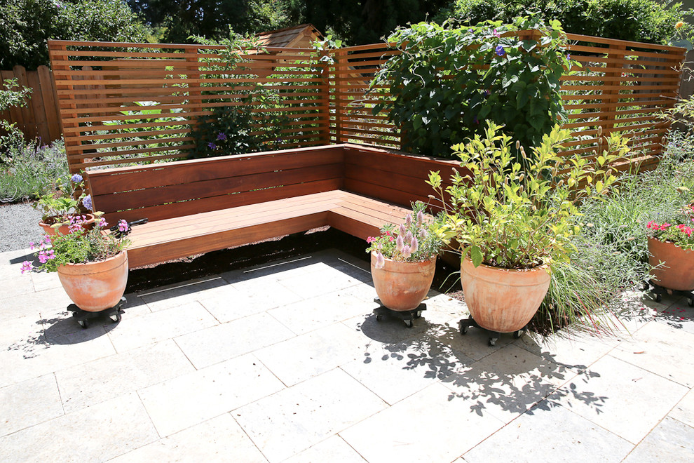 This is an example of a mid-sized transitional full sun backyard stone water fountain landscape in San Francisco for spring.