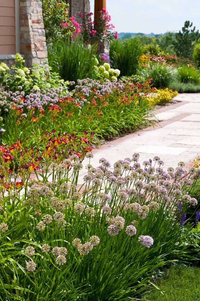 Inspiration for a mid-sized craftsman front yard stone garden path in Milwaukee.