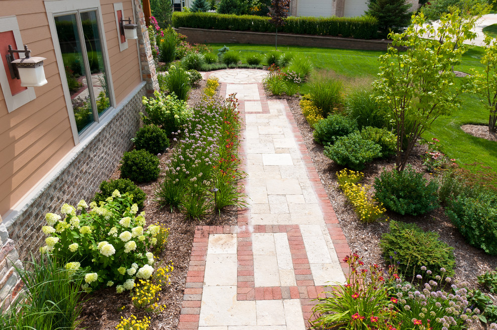This is an example of a mid-sized craftsman front yard stone garden path in Milwaukee.