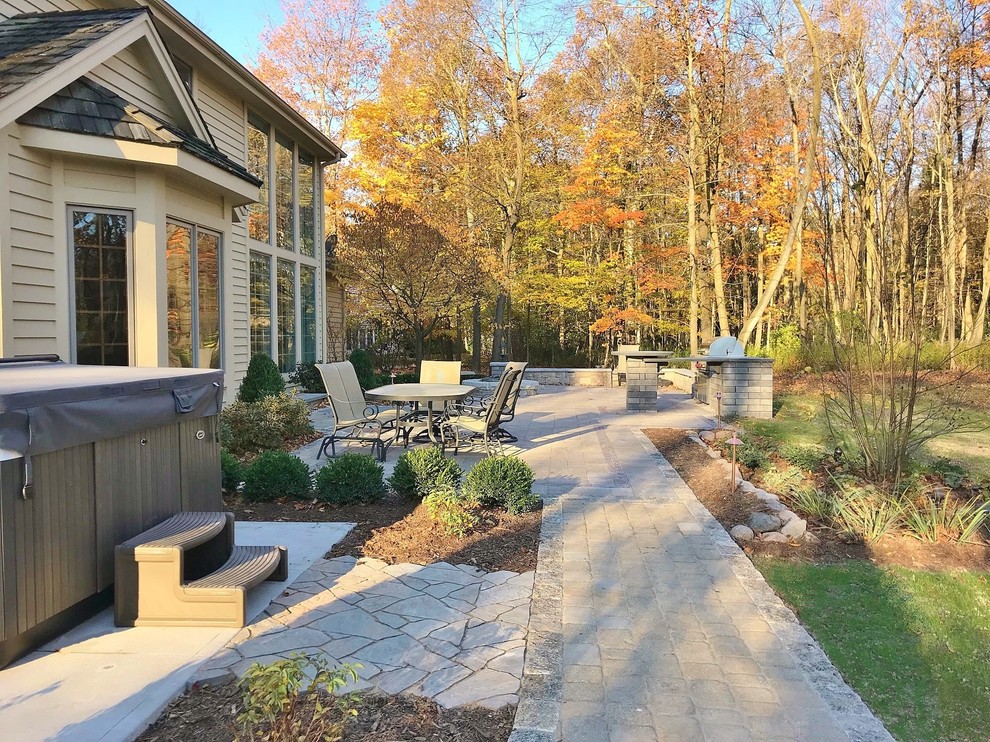 Design ideas for a large classic back partial sun garden in Milwaukee with concrete paving.