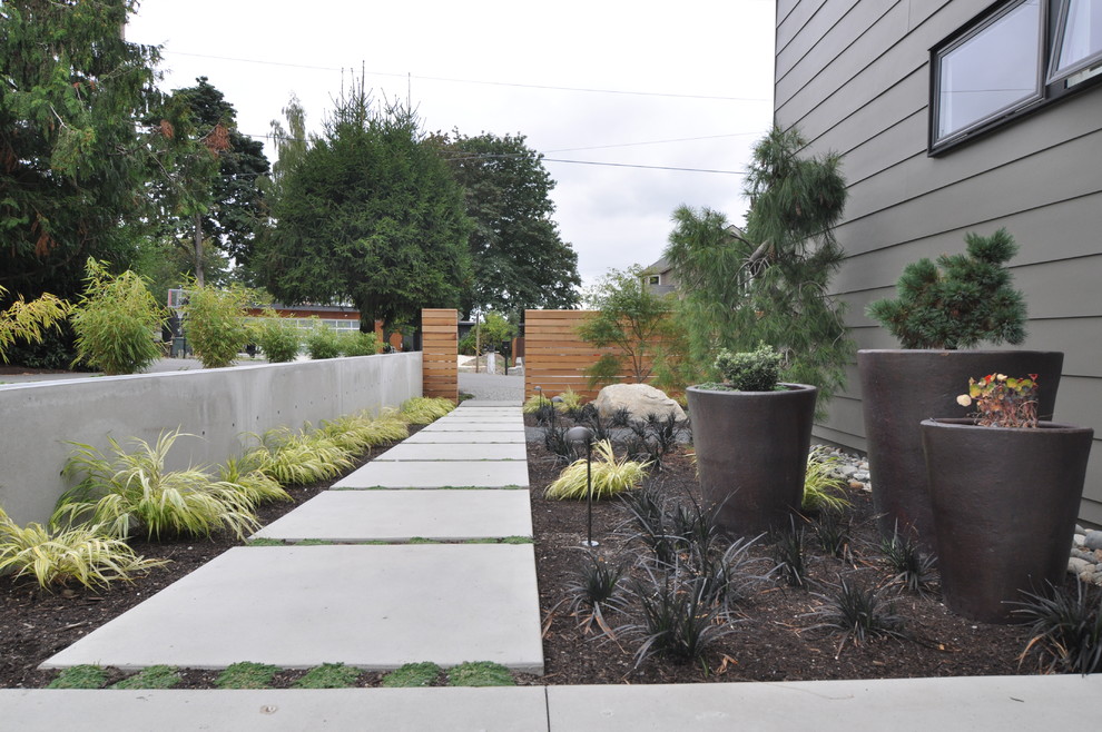 Design ideas for a large contemporary full sun side yard concrete paver water fountain landscape in Seattle for summer.