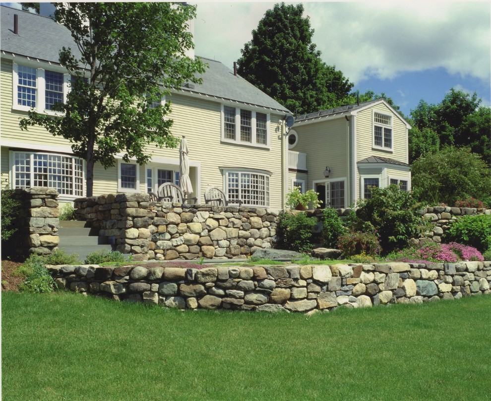 Inspiration for a large farmhouse full sun backyard stone landscaping in Boston for fall.