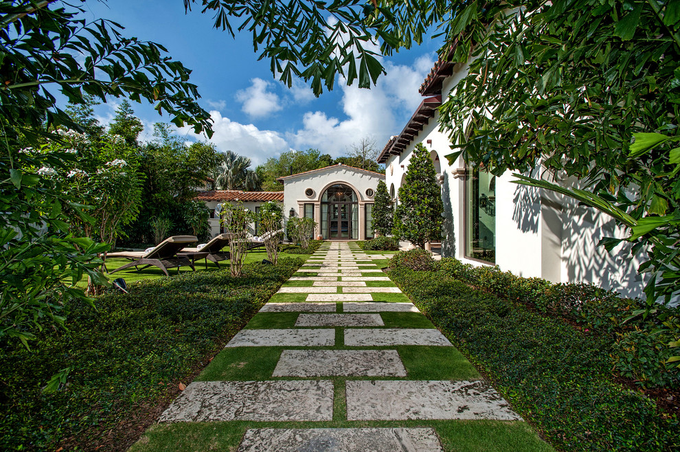 This is an example of a mediterranean backyard landscaping in Miami.