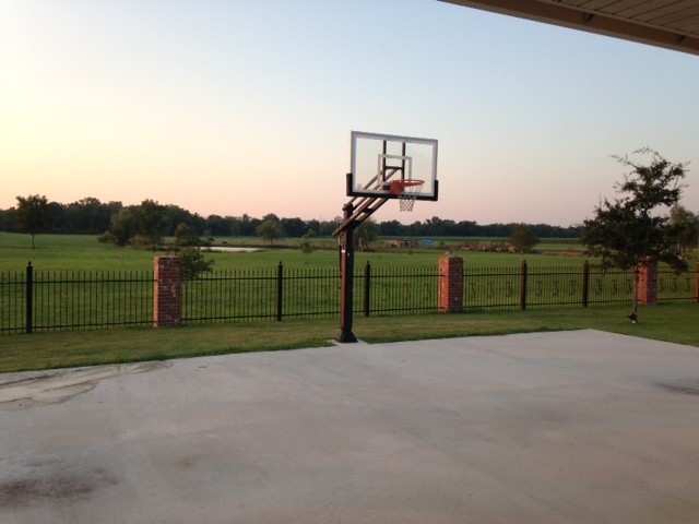 Inspiration for a large classic back full sun garden in New Orleans with an outdoor sport court.
