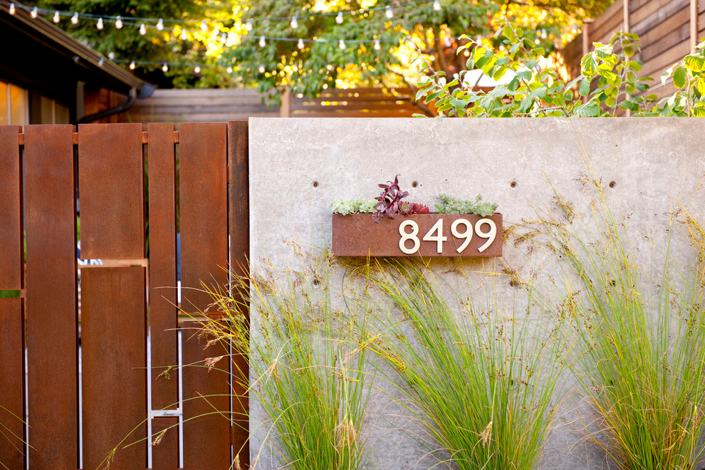 Inspiration for a small mid-century modern partial sun front yard stone garden path in Seattle.