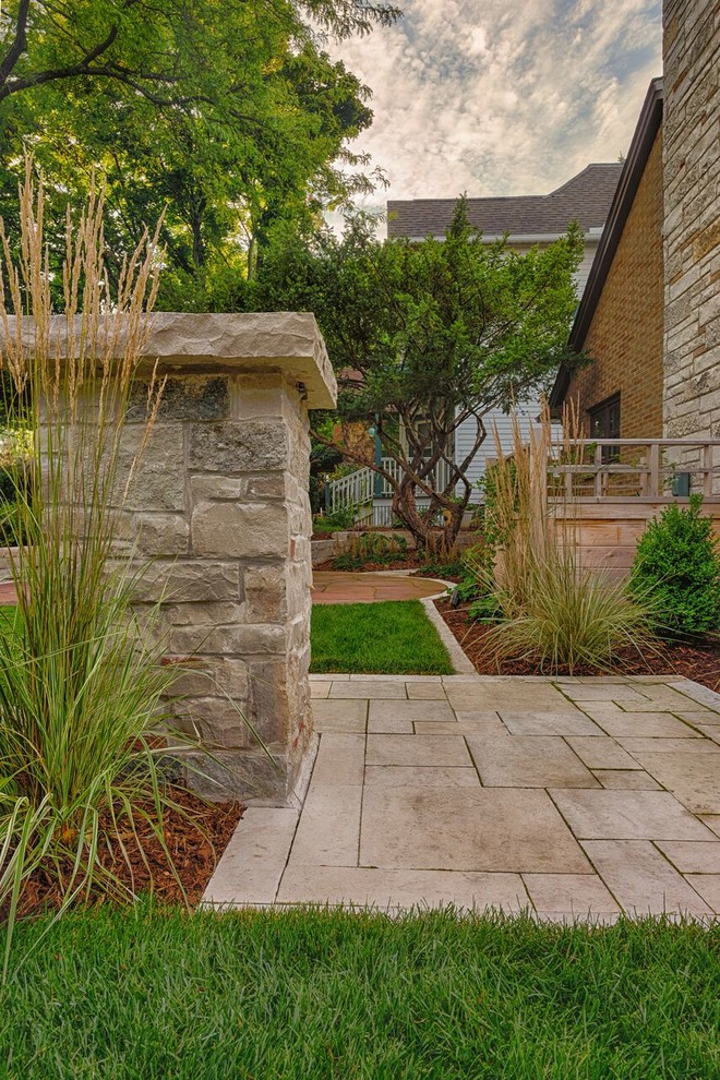 Photo of a small mid-century modern full sun side yard stone landscaping in Milwaukee.