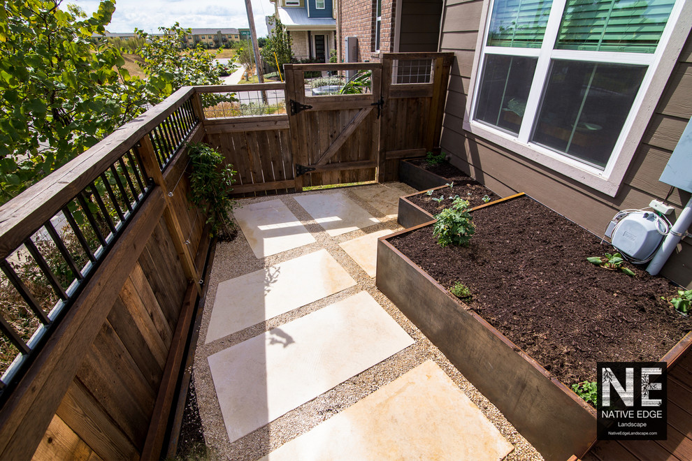 This is an example of a small modern drought-tolerant courtyard concrete paver vegetable garden landscape in Austin.