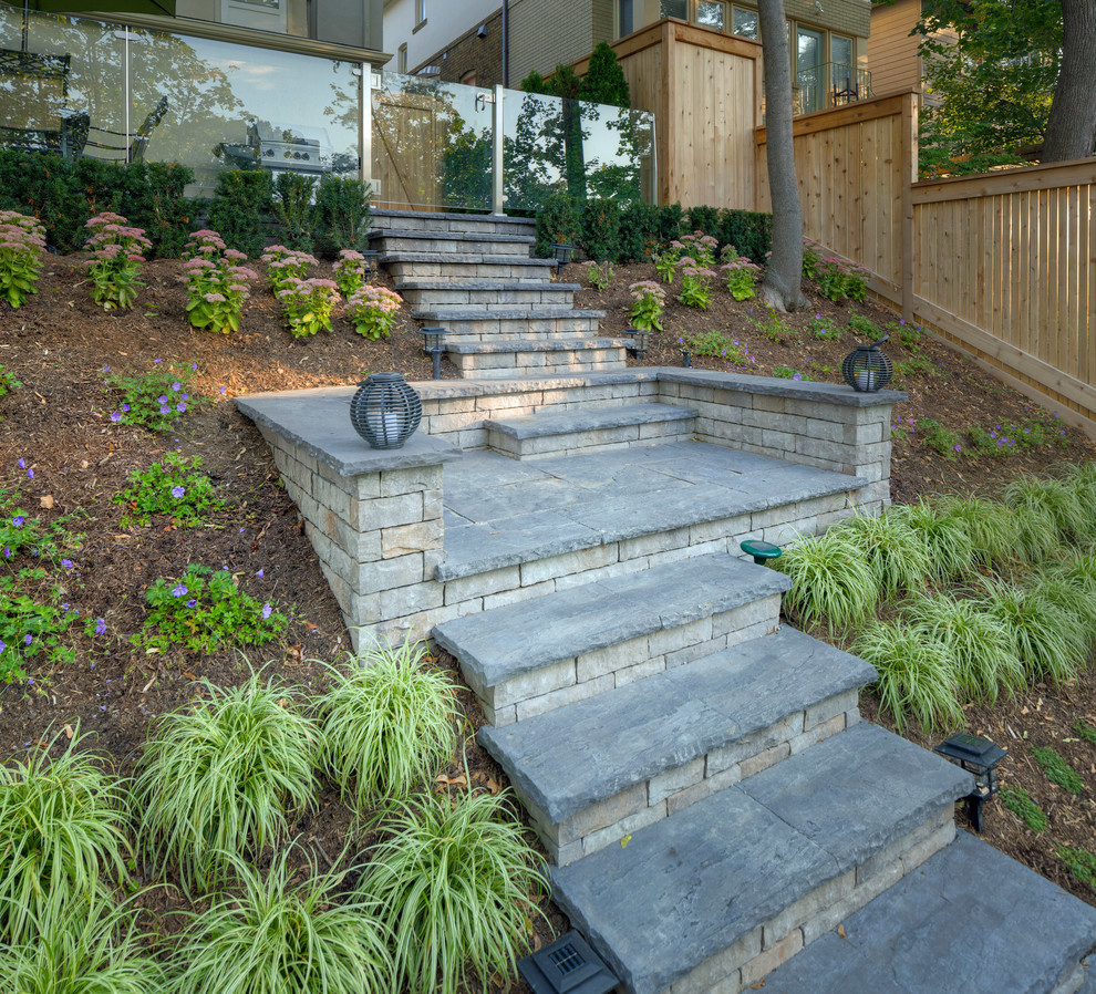 Inspiration for a medium sized modern back formal full sun garden for summer in Toronto with a retaining wall and concrete paving.
