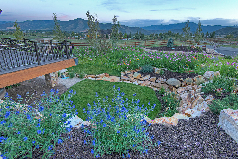 Medium sized rustic front formal partial sun garden for summer in Salt Lake City with a water feature and mulch.