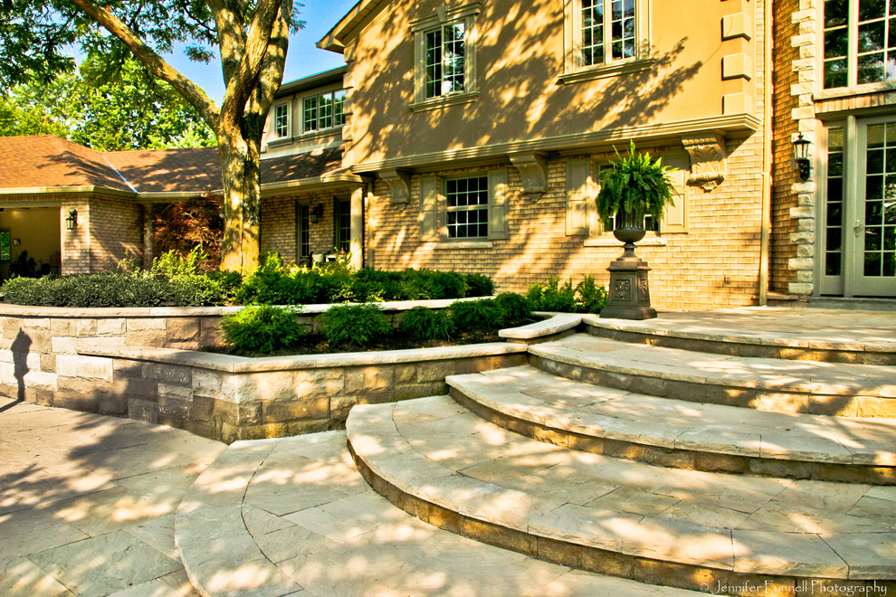 Photo of a large traditional partial sun front yard stone garden path in Toronto for spring.