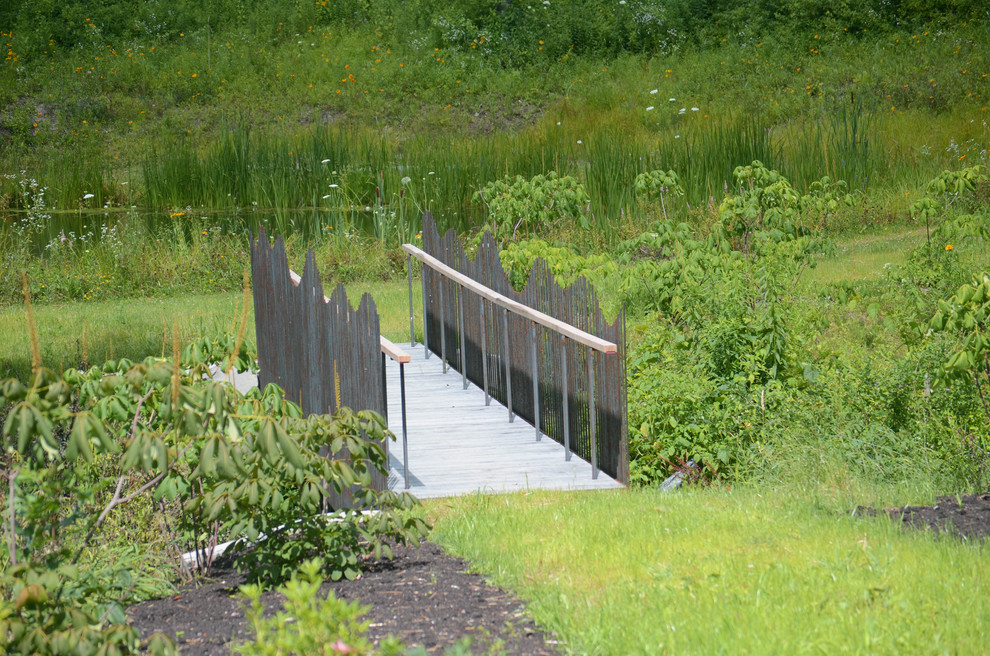 Cette photo montre un jardin montagne l'été avec une exposition ensoleillée et une terrasse en bois.