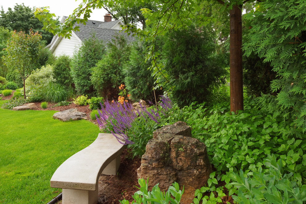 This is an example of a medium sized traditional back formal garden for summer in Minneapolis with a garden path.