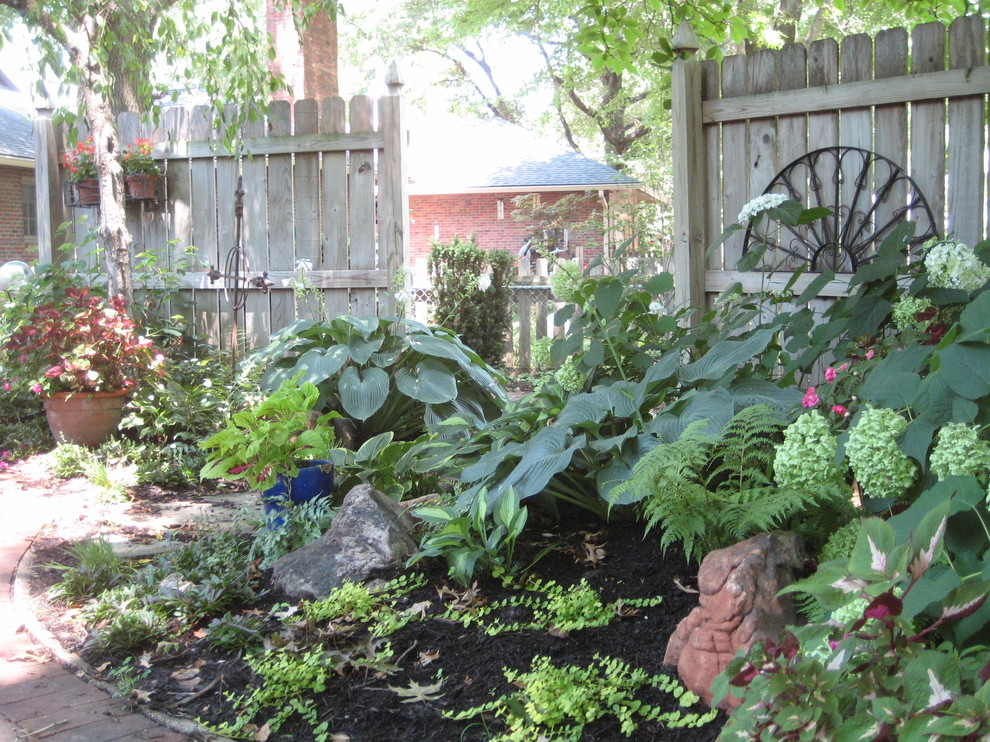 This is an example of a small transitional shade backyard landscaping in Kansas City for summer.