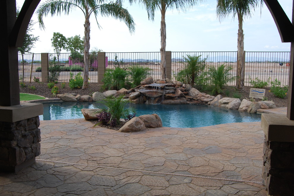 Design ideas for a mid-sized southwestern full sun backyard stone water fountain landscape in Phoenix for summer.