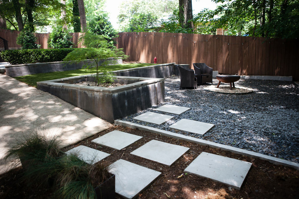 Design ideas for a medium sized contemporary back partial sun garden for autumn in Atlanta with a retaining wall and gravel.