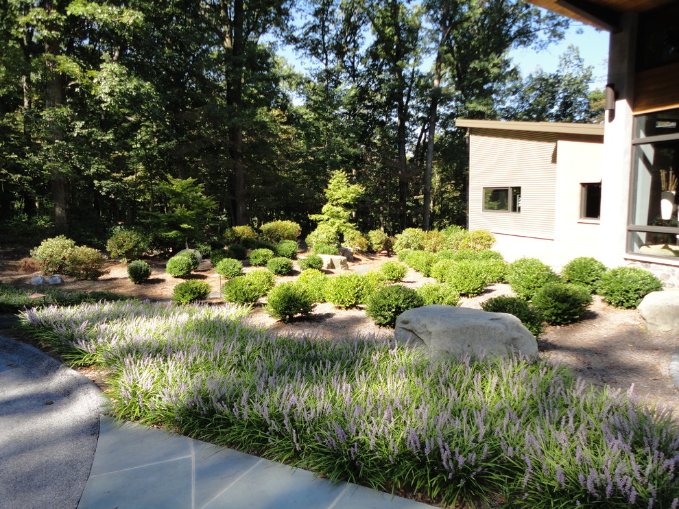 Design ideas for a large modern partial sun front yard stone landscaping in Other.