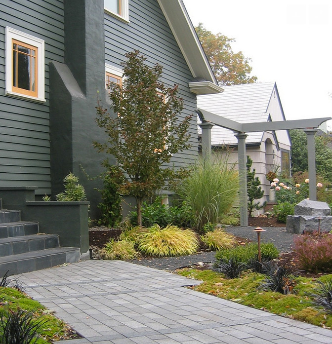 Photo of a medium sized bohemian front formal partial sun garden for summer in Portland with concrete paving.