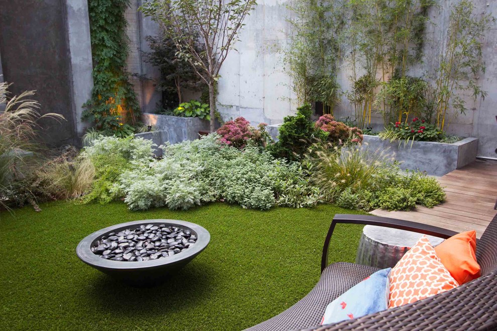 This is an example of a contemporary garden in New York with a fire feature.