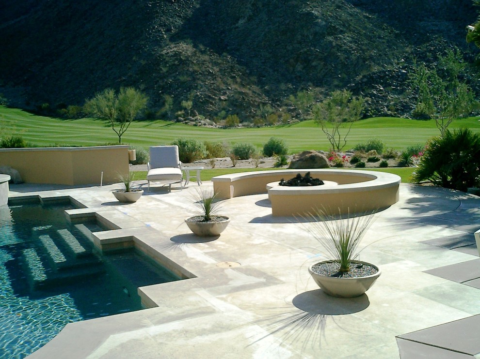 Design ideas for a large modern full sun backyard concrete paver landscaping in San Diego with a fire pit for winter.