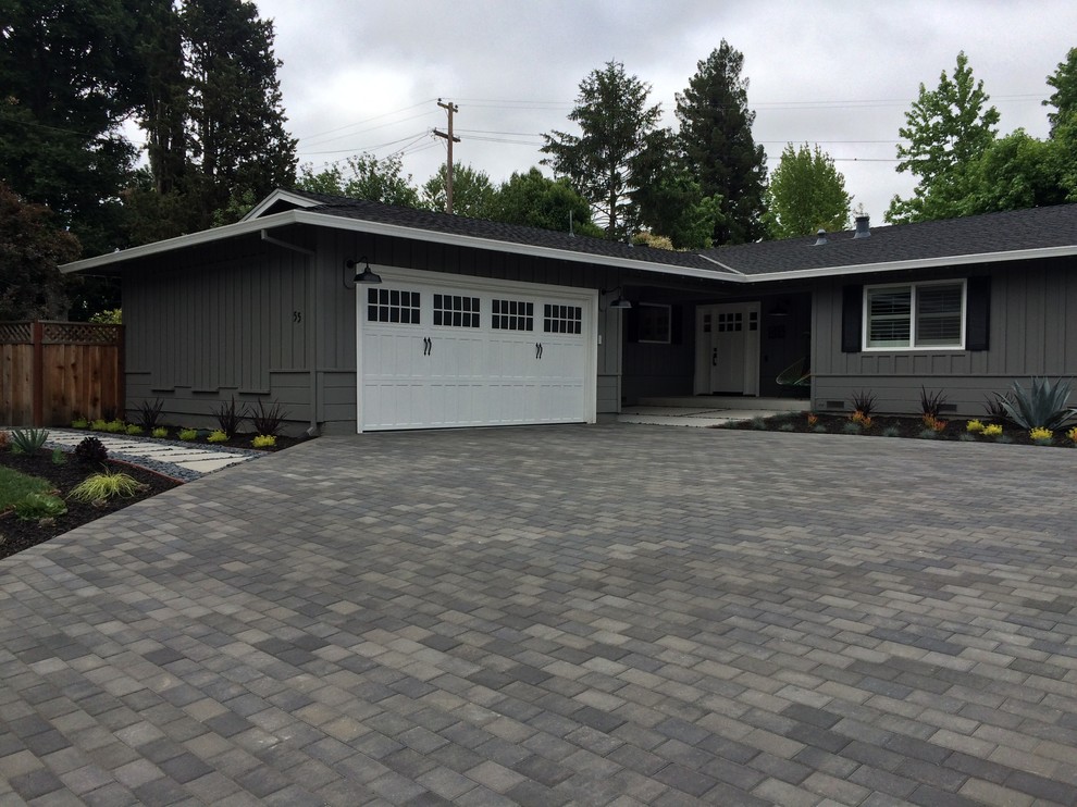 This is an example of a mid-sized modern full sun front yard concrete paver driveway in San Francisco.