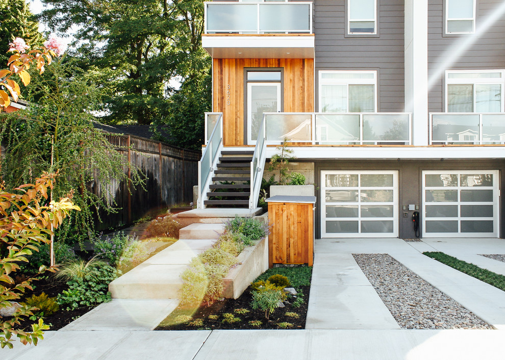 Diseño de acceso privado moderno de tamaño medio en patio delantero con adoquines de hormigón