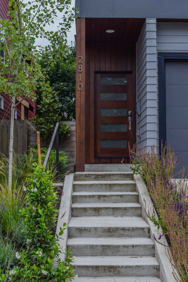 Design ideas for a small contemporary front xeriscape partial sun garden in Portland with concrete paving.
