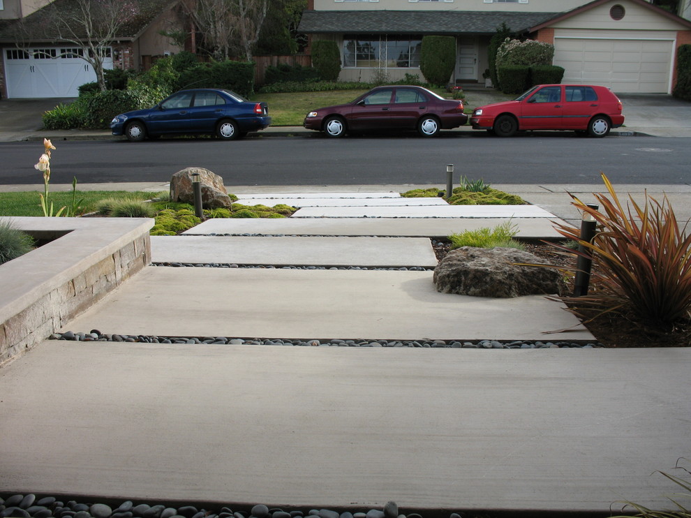 This is an example of a small modern full sun front yard concrete paver garden path in San Francisco.