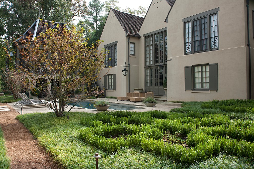 This is an example of a french country backyard landscaping in Birmingham.