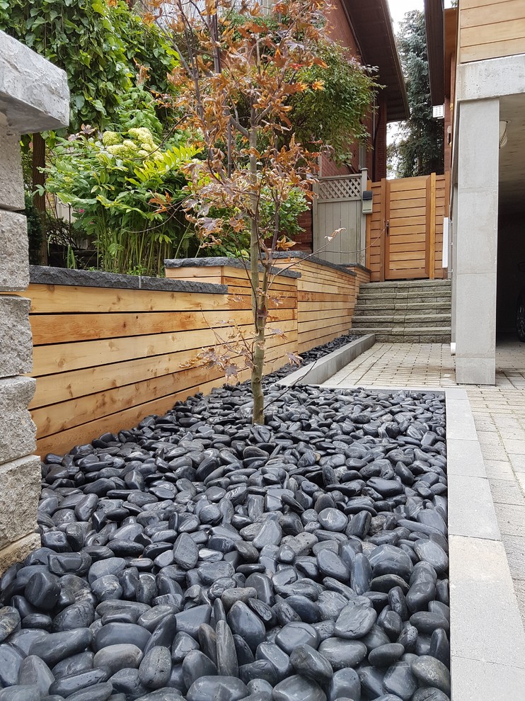 Inspiration for a mid-sized modern partial sun front yard concrete paver landscaping in Toronto.