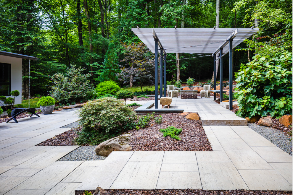 Inspiration for a large modern partial sun backyard concrete paver formal garden in Philadelphia.